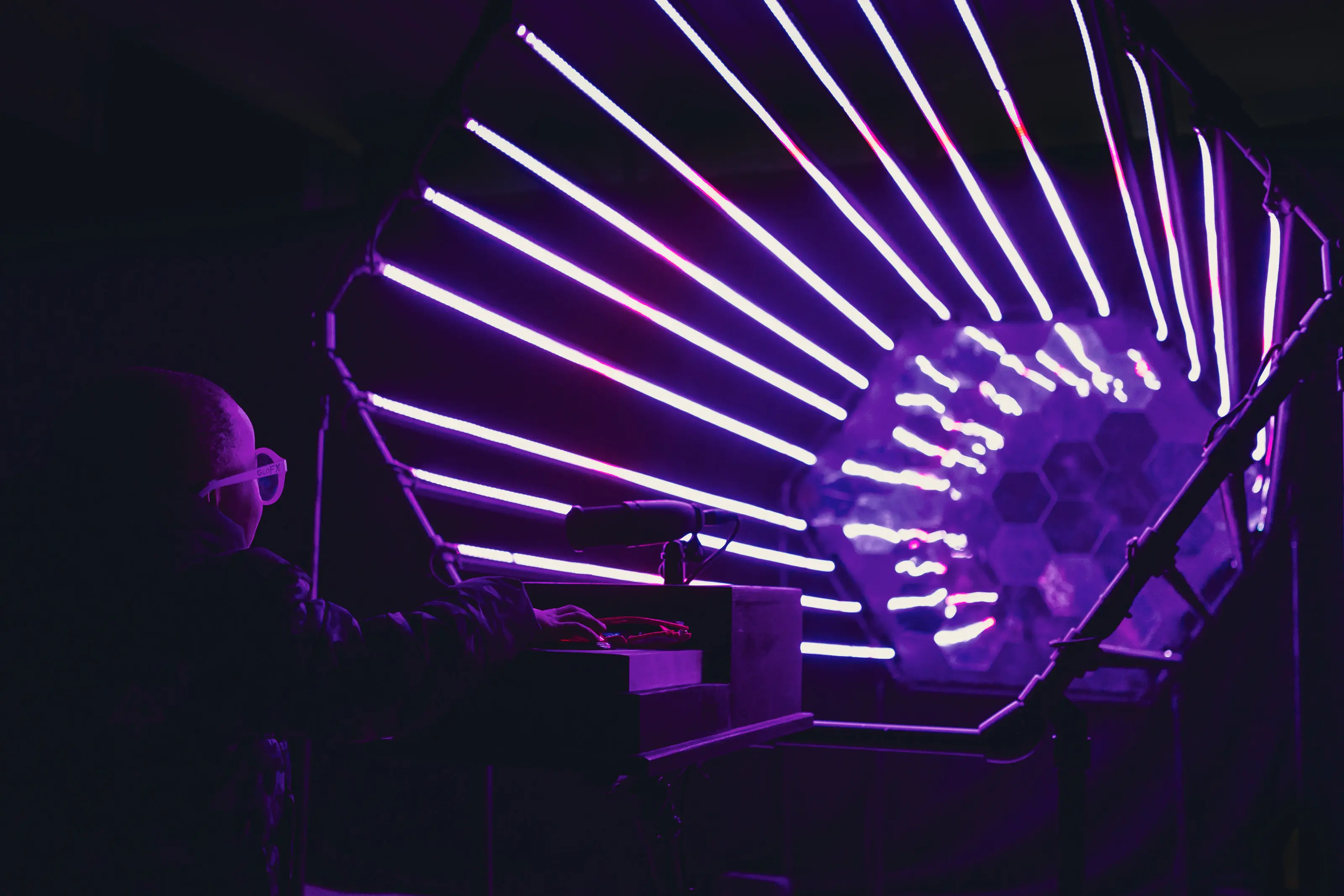 Participant engaged with the Awaken piece as dynamic lighting patterns pulse around the space